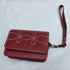 Icon Red Leather Wristlet Wallet with a decorative swirl/boot stitch pattern.